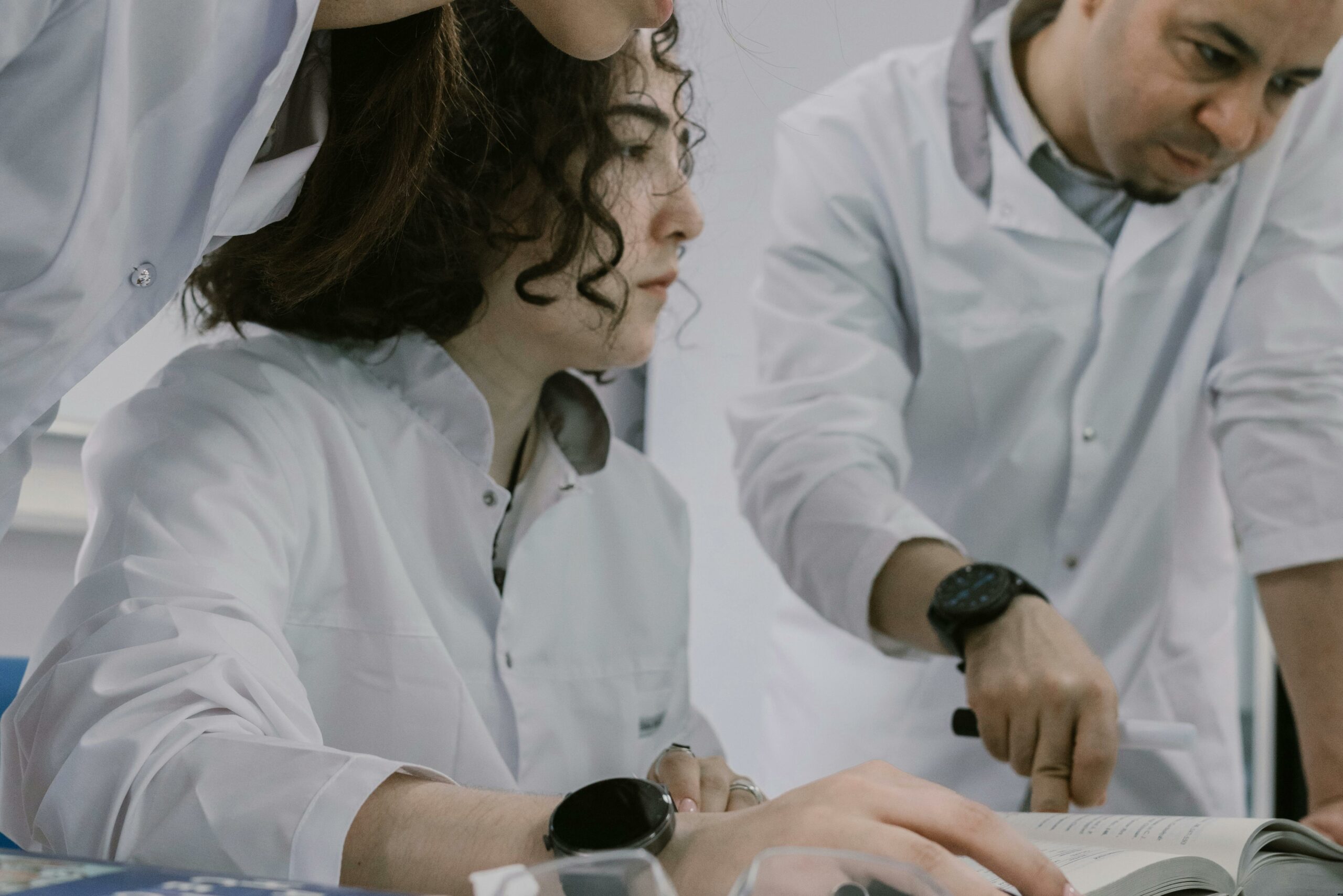 Group of scientists working together in a lab, focused and collaborative atmosphere.